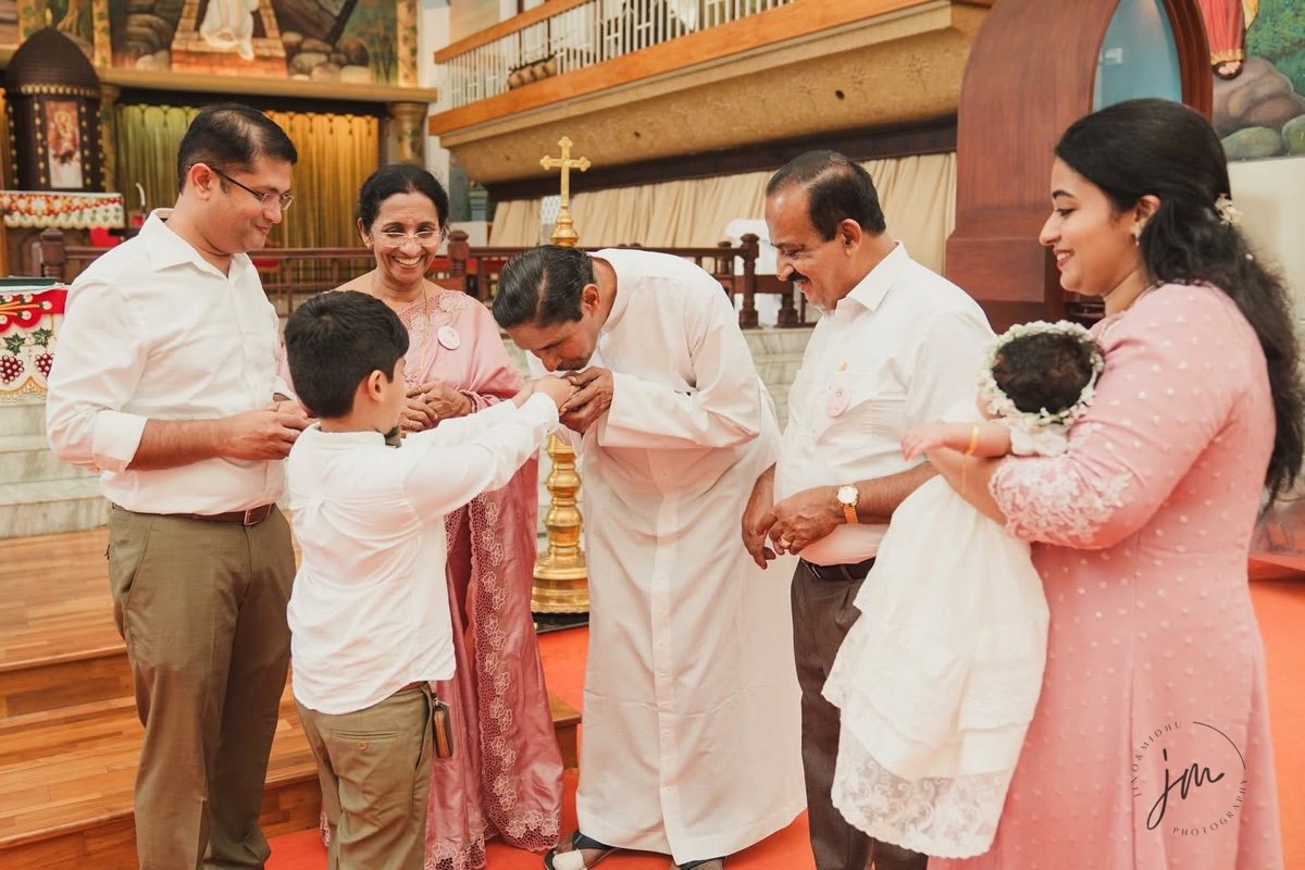 Sacred family tradition and blessing across generations by Jino and Midhu